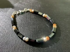 Bracelet in black glass beads and orange crystal