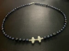 White cross shaped pearl with black baroque pearl and silver bar necklace